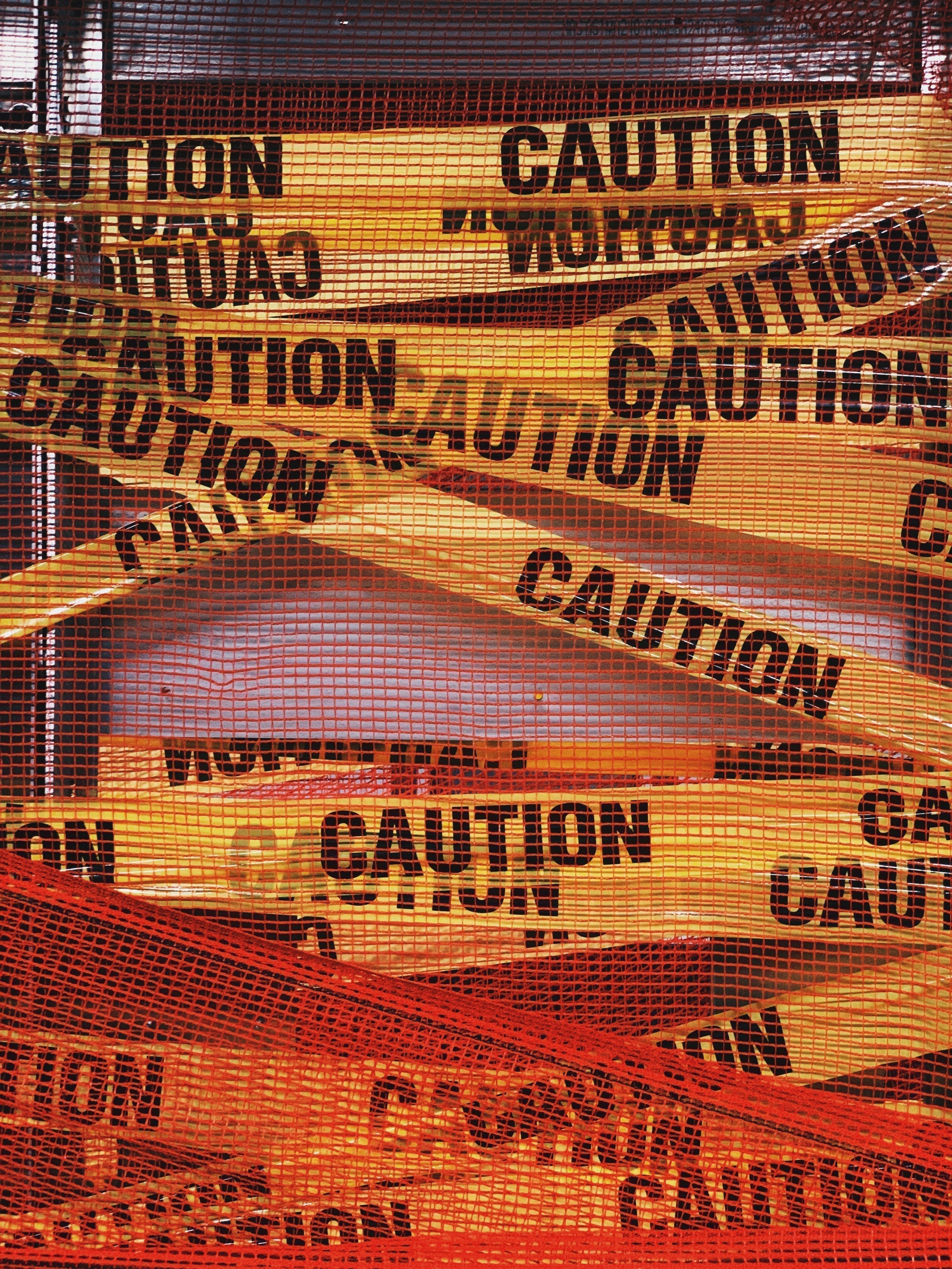 Yellow caution tape and red safety netting used to represent shilajit safety, side effects, and supplement quality concerns.