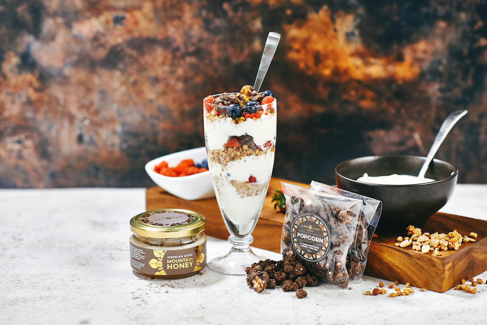 Dark chocolate popcorn with chia and hemp served with yoghurt, berries, and granola