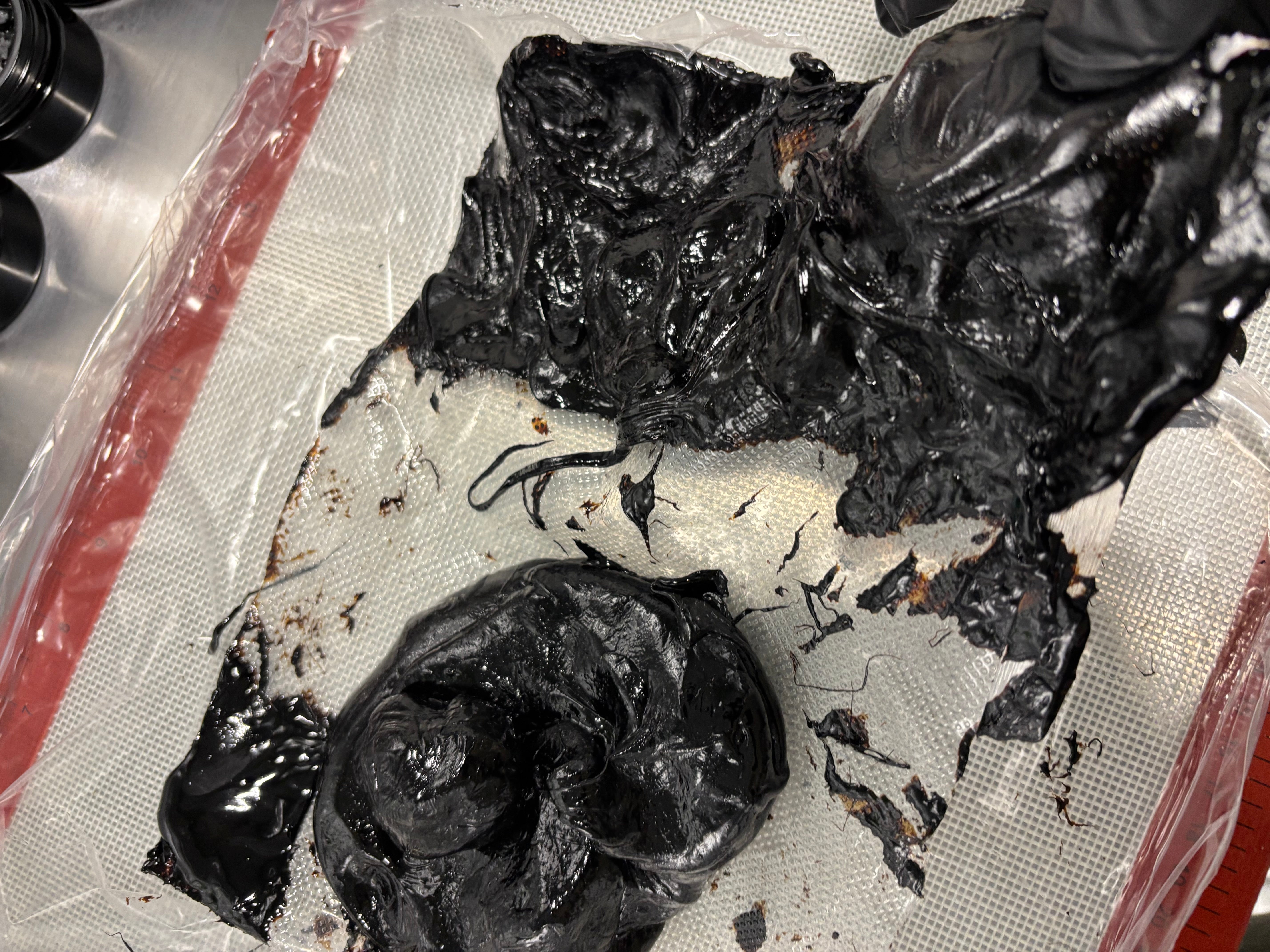 Sticky Shilajit resin, showing dense black texture and natural tackiness before jarring.