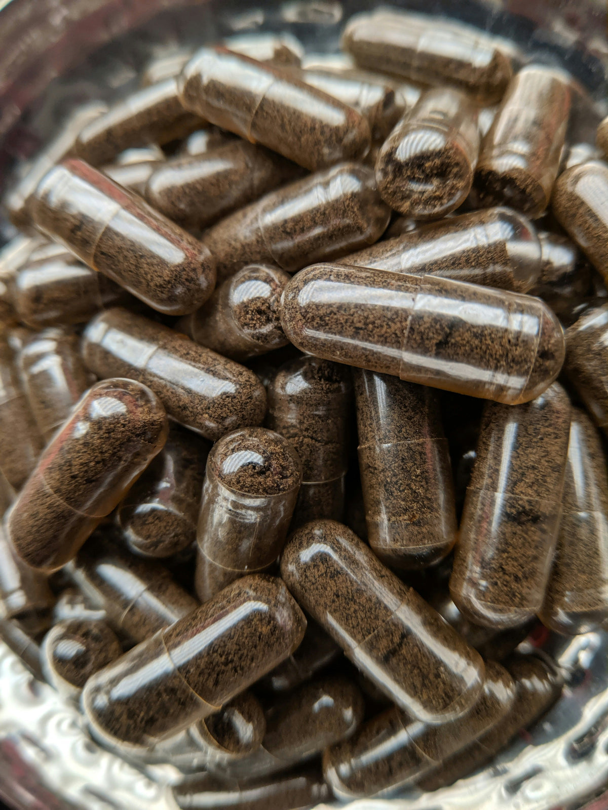 Brown supplement capsules grouped together in a container