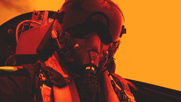 Fighter pilot wearing a helmet and oxygen mask in cockpit against an orange background.