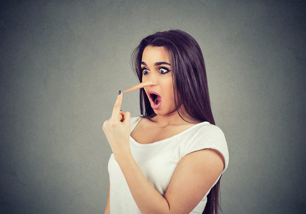 Woman with a long nose representing misleading marketing or false claims.