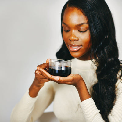 Woman drinking Chaga mushroom tea as part of daily routine