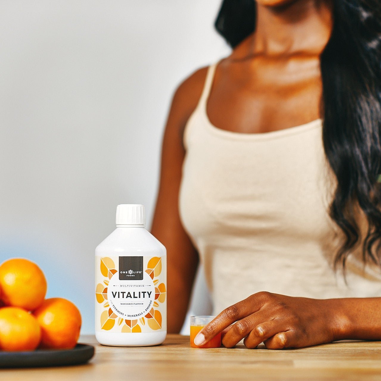Vitality liquid multivitamin with daily serving being poured