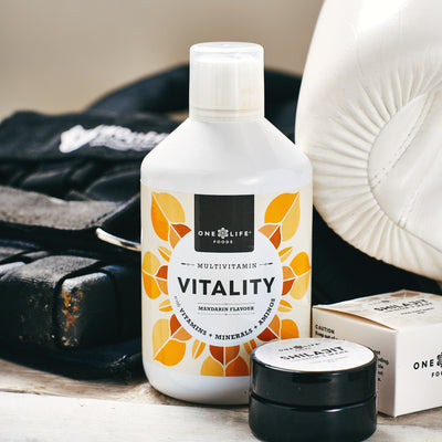 Vitality liquid multivitamin bottle with boxing glove, weighted vest and  One Life Foods products